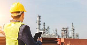 Payne-Industries in Caldwell, Texas - Image of man with hard hat doing oil and gas surveying