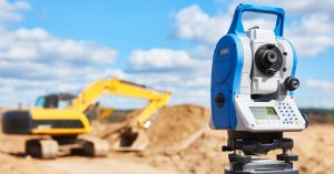 Payne-Industries in Caldwell, Texas - image of land surveying equipment and construction vehicle in background